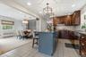 View from the beautiful Kitchen & center island towards the additional breakfast area with built-in banquet. (Tile continues under the Family Room rug