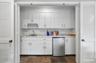 Behind these bifold doors in the Rec Room, you'll find a newly updated summer/entertaining kitchen with new sink and counter. Perfect compliment to th