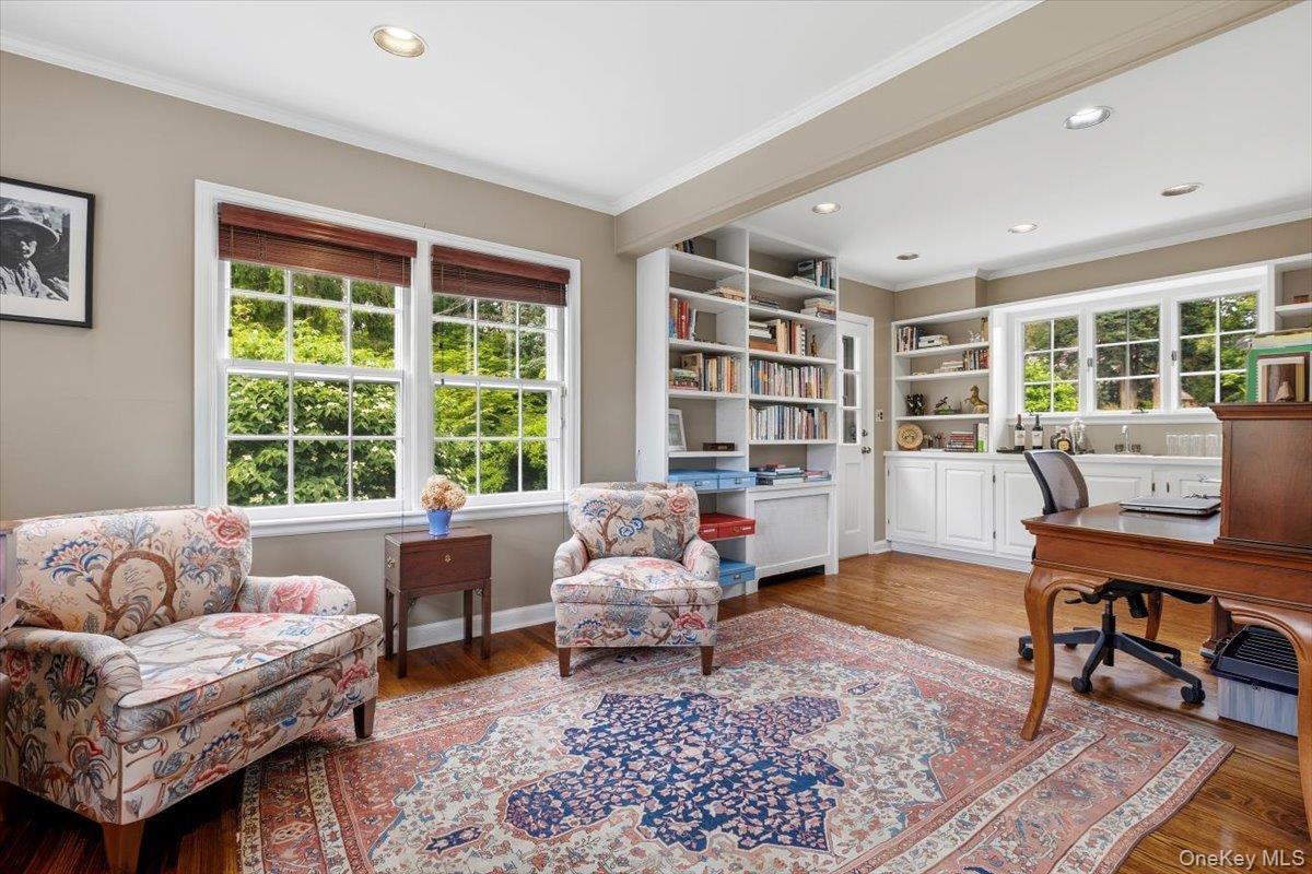 Off one side of the Living Room is this combined Den/Office with a sitting area and separate office area with built-in bookshelves and cabinetry.