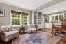 Off one side of the Living Room is this combined Den/Office with a sitting area and separate office area with built-in bookshelves and cabinetry.