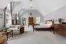 Rivaling anything you've seen, this dramatic Primary Bedroom Suite with high tray ceiling, two custom walk-in closets, recessed lights & ceiling fan w