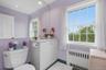 In addition to the full Bathroom in the bedroom wing, there is this updated half bathroom upstairs.
