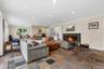 The Recreation Room also offers a 2nd wood-burning fireplace with marble surround. In the distance you'll see an area dedicated to exercise equipment.