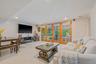 Living room with light tile patterned floors and recessed lighting