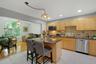 Kitchen to Family Room with hardwood floors and large arched window for plenty of sunlight