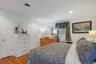 Primary bedroom with doors to ensuite bath and walk in closet