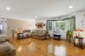Living room with hardwood floors and bay window, recessed lighting