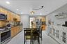 Kitchen with movable island, stainless appliances, recessed lighting