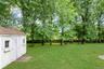 Level yard with the privacy, mature trees and a shed