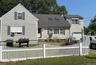 Traditional-style home featuring a shingled roof and an attached garage