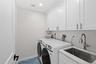 2nd floor laundry room equipped with additional sink and plenty of storage!
