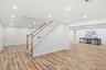 Big basement with 4 oversized egress windows wood floor look luxury vinyl