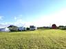 View of grassy yard featuring an outbuilding