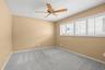Bedroom 3 - ceiling fan, walk-in closet, and plantation shutters