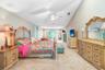Expansive master bedroom 14' x 37' with vaulted ceilings and large sitting area and french doors out to pool/patio area.