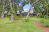 Great view of back side of home through the trees.