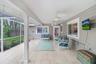 Relaxing patio area under roof with ceiling fans, perfect for parties and barbeques.