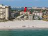 This photo highlights the building's prime location and its immediate proximity to the beach.