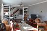 Living area featuring ornamental molding, wood finished floors, stairway, and a ceiling fan