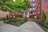Front entrance with immaculately maintained landscaping offers a warm welcome to this pre-war building