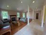 view of LR, DR, gas fireplace, to patio doors.