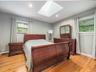 Hardwood flooring complemented by a skylight and recessed lighting