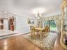 Formal dining area featuring hardwood flooring, crown molding, and a decorative chandelier with a ceiling medallion