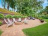 Expansive paver patio featuring a built-in stone fire pit