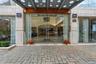 Modern building entrance featuring a stone-clad facade and automatic glass doors