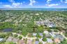 Drone view of property and neighborhood