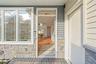 Entrance to property featuring stone siding
