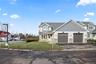 Craftsman inspired home featuring stone siding, asphalt driveway, a front yard, and a garage