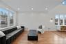 Living area featuring light wood-style floors and recessed lighting
