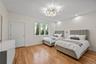 Bedroom with light wood finished floors, a chandelier, and recessed lighting