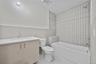 Bathroom featuring vanity, tile walls, tub / shower combination, and tile patterned floors