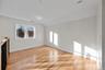 Empty room with vaulted ceiling and light wood-type flooring