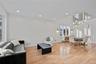 Living room with light wood finished floors, recessed lighting, and a chandelier