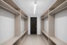 Virtually Staged walk-in closet area in lower  level.  Fabulous!