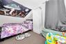 Bedroom featuring vaulted ceiling and carpet