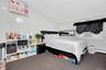 Carpeted bedroom featuring vaulted ceiling