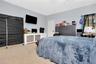 Carpeted bedroom with recessed lighting