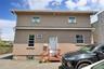 View of front of property featuring stucco siding and cooling unit