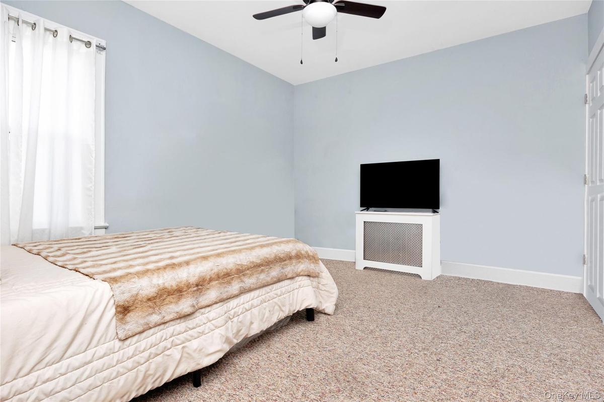 Bedroom featuring carpet and ceiling fan