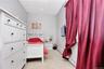 Bedroom featuring baseboard heating, light carpet, and a paneled ceiling