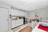 Kitchen with appliances with stainless steel finishes, light countertops, a paneled ceiling, white cabinets, and recessed lighting