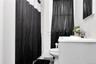 Full bath with vanity and a shower with shower curtain