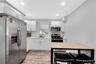 Kitchen featuring stainless steel appliances, ornamental molding, decorative backsplash, recessed lighting, and white cabinetry