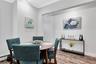 Dining area featuring wood finished floors, ornamental molding, and a baseboard heating unit