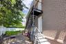 Patio / terrace with stairs, a patio, and a water view