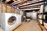 Unfinished below grade area with independent washer and dryer